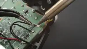 Use your <a href="../../home/unavailable_offline?url=/products/fixhub-power-series-smart-soldering-iron" target="_blank" class="product-link">soldering iron</a> to heat up one of the motor wire solder pads.