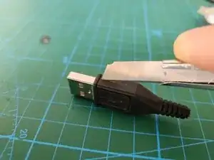 Removing the USB connector from a moulded cable