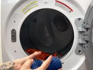 Toss in 2–3 dryer balls, clean tennis balls, or rolled-up socks.
