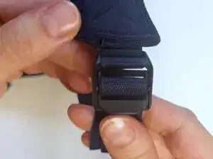 Push the bottom of the duck bill clip up and away from the square piece.