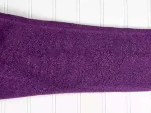 Lay your sweater flat on a clean surface. Focus on one pilled area at a time.
