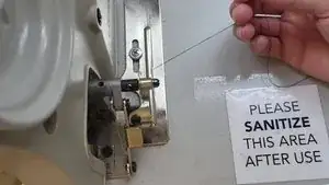 Hold the thread for a few seconds while gently pressing the pedal down.