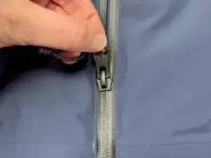 If the slider is stuck and won't budge along the zipper track, it's often because a few teeth are slightly misaligned inside the slider.