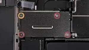 After disconnecting the initial ribbons, you’ll notice the screen remains attached by one additional ribbon. Remove the cover and carefully detach this final connection.