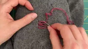 Continue until the hole is covered and the last row of yarn is at least 1/4 inch (~6 mm) beyond the damage.