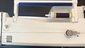 The bobbin will spin and fill with thread.