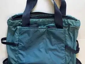Pull the backpack straps out of the top stash pocket on the back of the tote.
