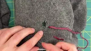 Use the yarn as a guide for where to stitch on the opposite side of the damage.