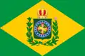 Bandeira do Império Brasileiro durante o Primeiro Reinado, com um ramo de café à esquerda