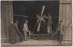 Alexandre Sallès (à esquerda) em frente a um hangar de aviões
