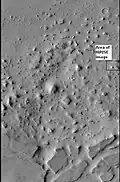 O quadrado na imagem destaca a área da próxima imagem da HiRISE. As protuberâncias e mesas foram provavelmente formados pela erosão de depósitos de uma antiga cratera.