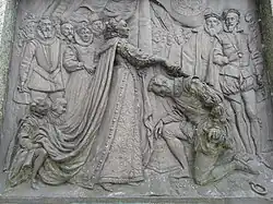 Drake recebe o título de cavaleiro da Rainha Elizabeth. Placa de bronze de Joseph Boehm, 1883, base da estátua de Drake, Tavistock