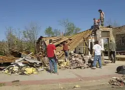 Well-built structures can suffer serious damage, including roof loss, and the collapse of some exterior walls may occur in poorly built structures. Mobile homes, however, are destroyed. Vehicles can be lifted off the ground, and lighter objects can become small missiles, causing damage outside of the tornado's main path. Wooded areas have a large percentage of their trees snapped or uprooted.