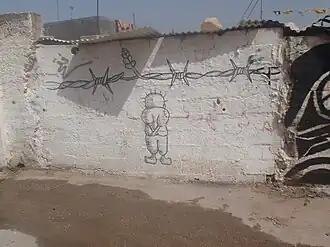 Handala em um muro em Bil'in