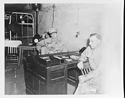 Two men sitting at a desk.