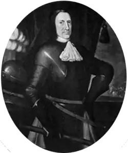 Imagem em preto e branco de um homem de rosto severo em armadura completa do início da era moderna e uma gola de pescoço branca