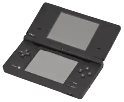 An opened clamshell dual-screen handheld device. A camera is embedded in the internal hinge.