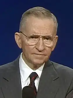 Um still do primeiro debate televisionado de 1992 mostrando Ross Perot na frente de um fundo azul.