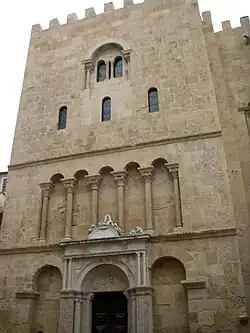 Sua fachada norte com janelas e colunas estreitas.
