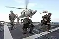 Um grupo de Navy SEALs desembarcando no navio.