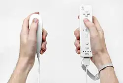 Two types of Wii controllers, one in each hand