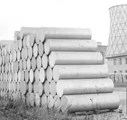 Extrusion billets of aluminium piled up before a factory