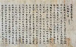 Photo couleur d'un texte calligraphié en japonais sur papier vieilli de couleur brune.