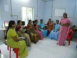 A group of women in India receiving instruction in health education