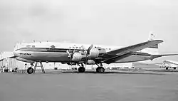 A black-and-white photograph of a JAL Douglas DC-6