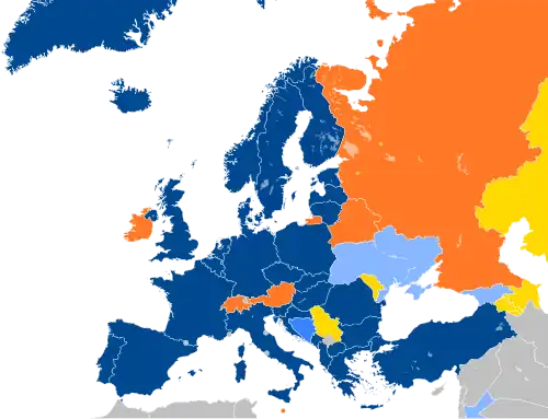 A map of Europe with countries in blue, cyan, orange, and yellow based on their NATO affiliation