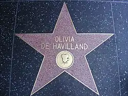 Five-pointed star with her name and an image of an old film câmera