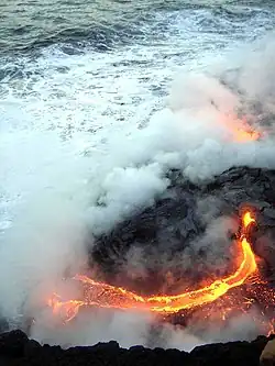imagem vista de cima de um escoamento de lava sobre o oceano