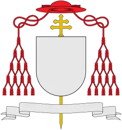 External ornaments of a cardinal's coat of arms, incorporating a scarlet galero with fifteen scarlet tassels on each side and a patriarchal cross behind the escutcheon and the motto