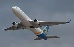 Ventral view of twin-jet aircraft in flight