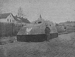 A man standing in front of an armored car