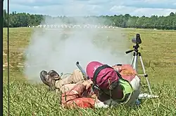 Competidor disparando a 1&nbsp;000&nbsp;jardas&nbsp;(914&nbsp;metros) deitado de costas.